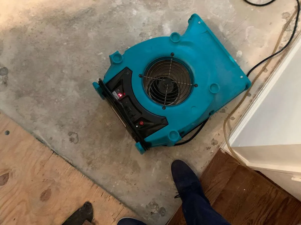 Air mover drying subfloor during Commercial Water Damage Restoration in Melvindale